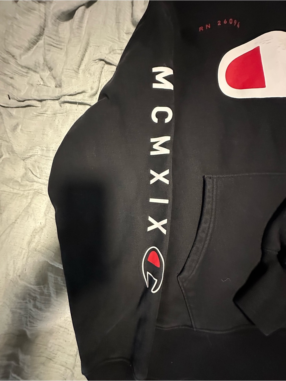 Champion Black Hoodie with White Sleeve Text and Red Logo Accent